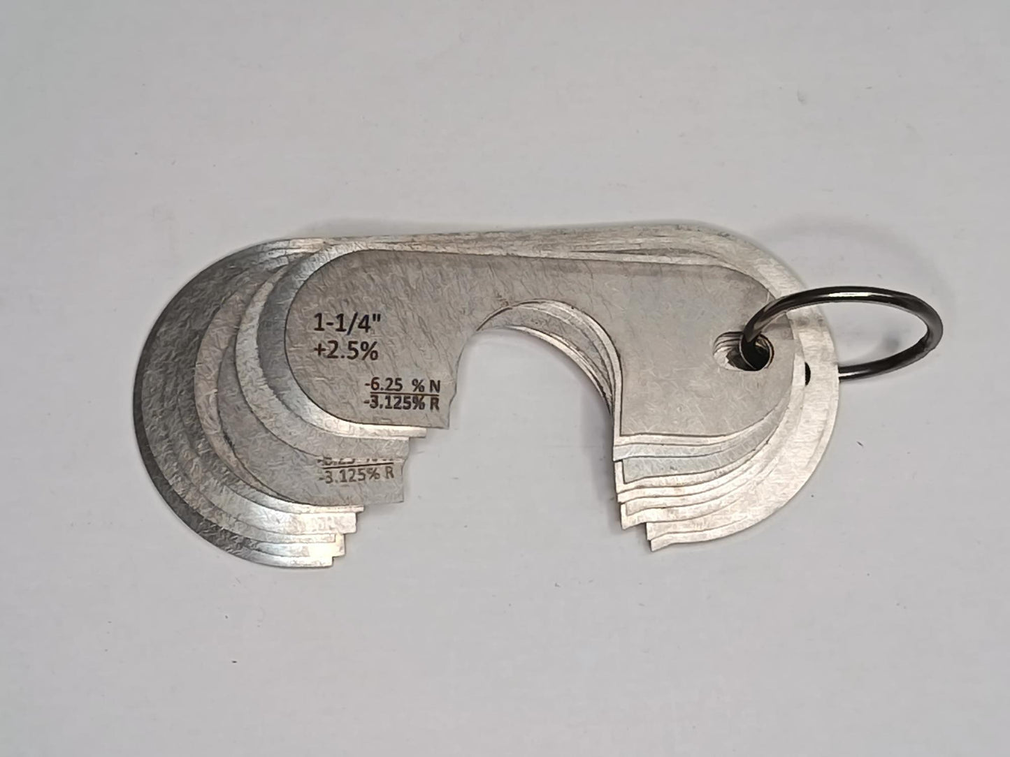 Metal measuring tool set with various scales on a grey background