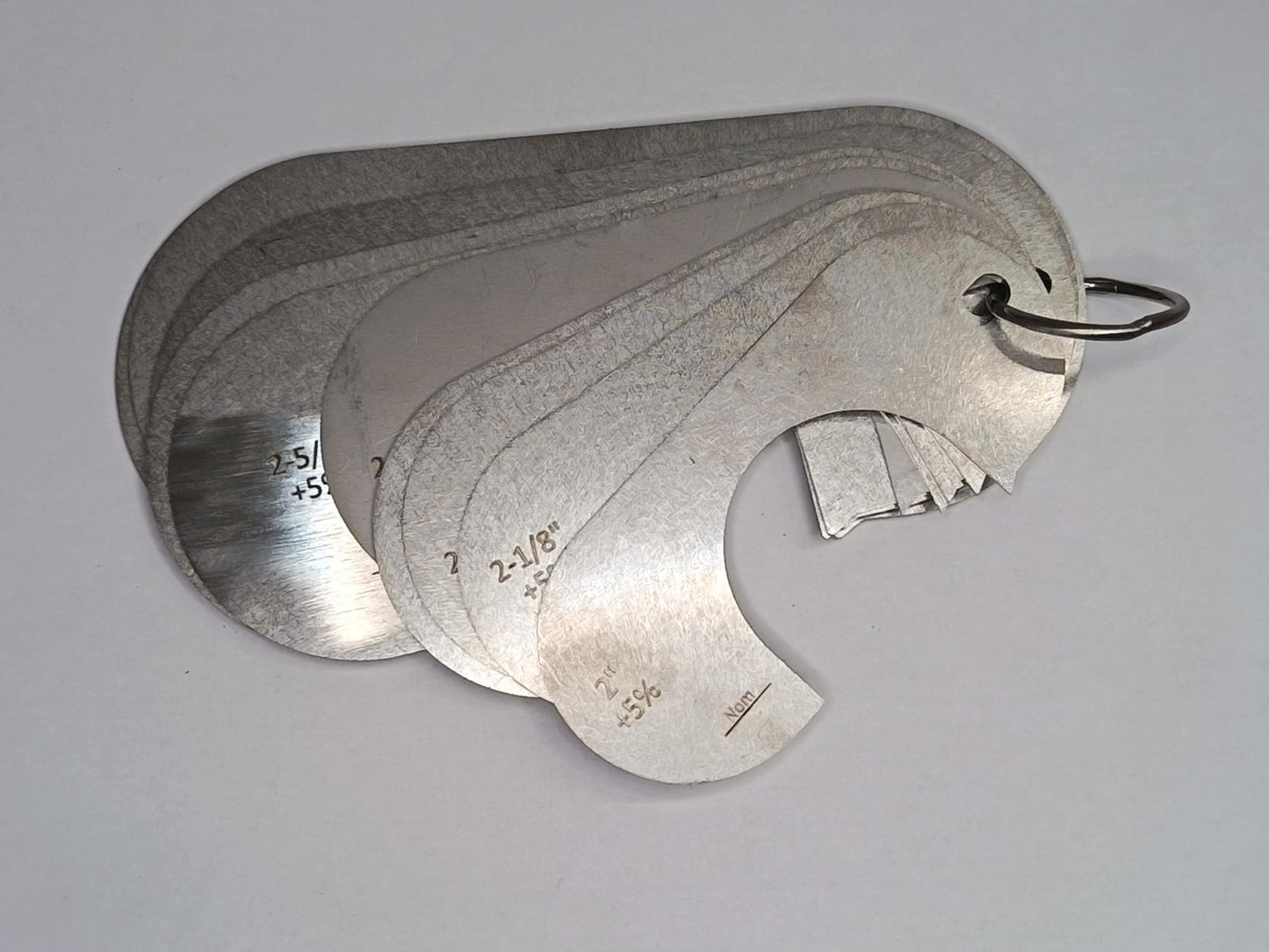 Metal measuring tool set with various scales on a grey background