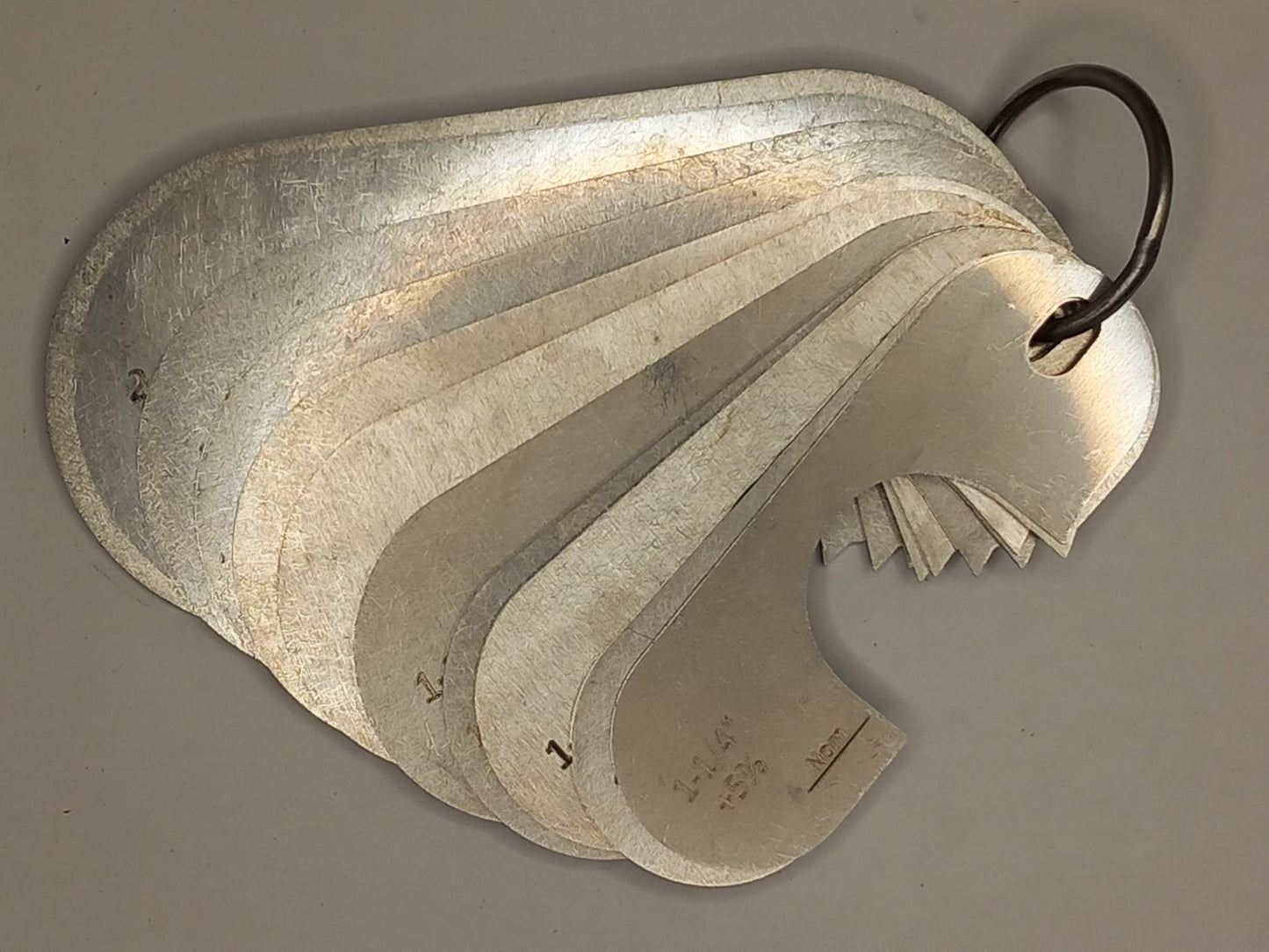 Metal measuring tool set with various scales on a grey background