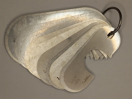 Metal measuring tool set with various scales on a grey background