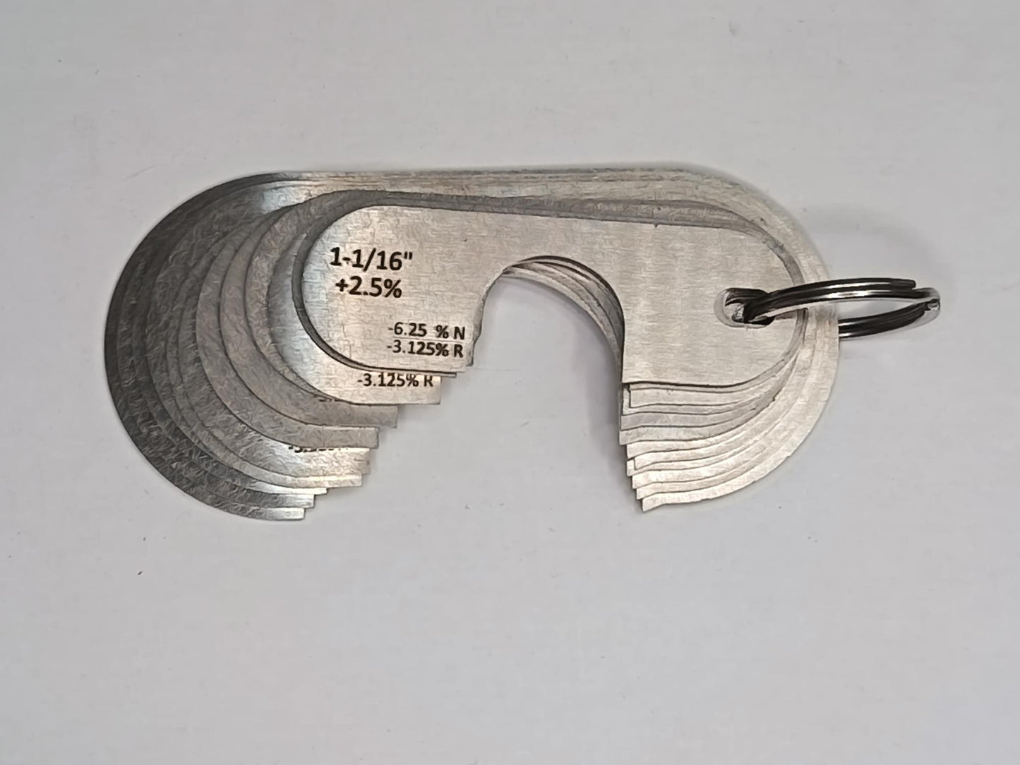 Metal measuring tool set with various scales on a grey background