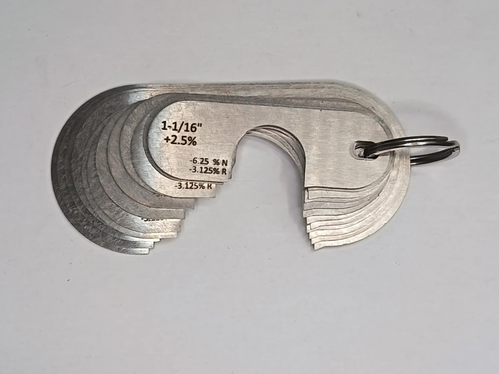 Metal measuring tool set with various scales on a grey background