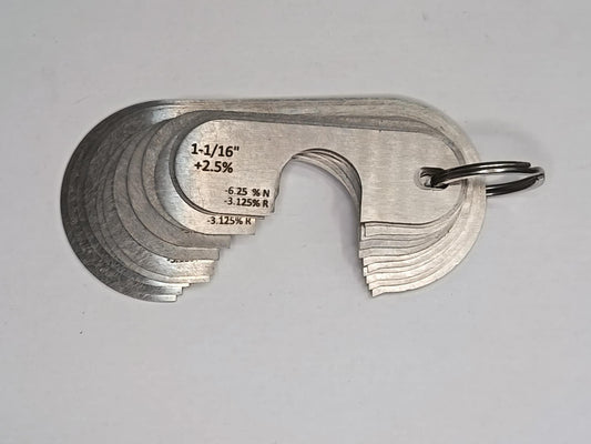 Metal measuring tool set with various scales on a grey background