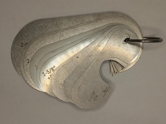 Metal measuring tool set with various scales on a grey background