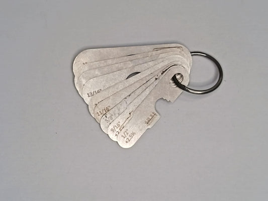 Metal measuring tool set with various scales on a grey background