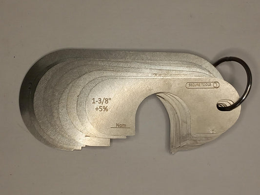 Metal measuring tool set with various scales on a grey background