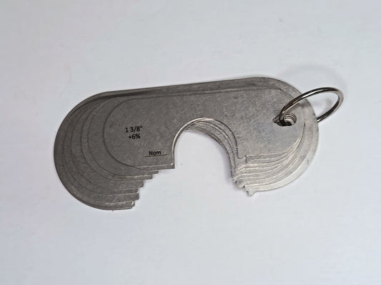 Metal measuring tool set with various scales on a grey background