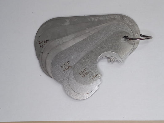 Metal measuring tool set with various scales on a grey background