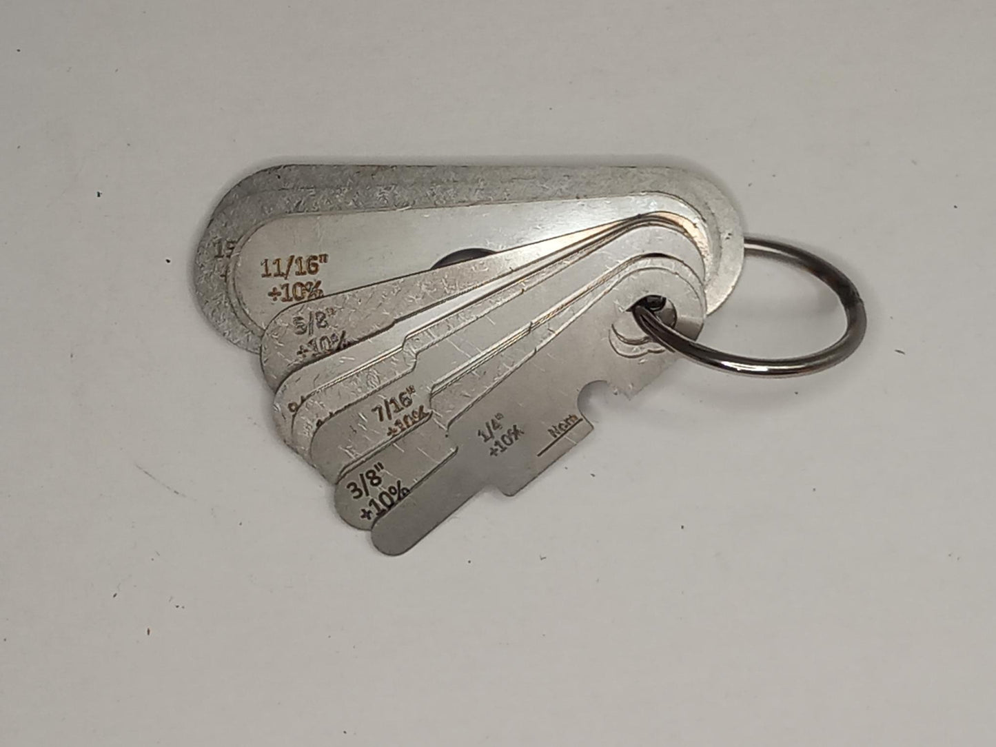 Metal measuring tool set with various scales on a grey background