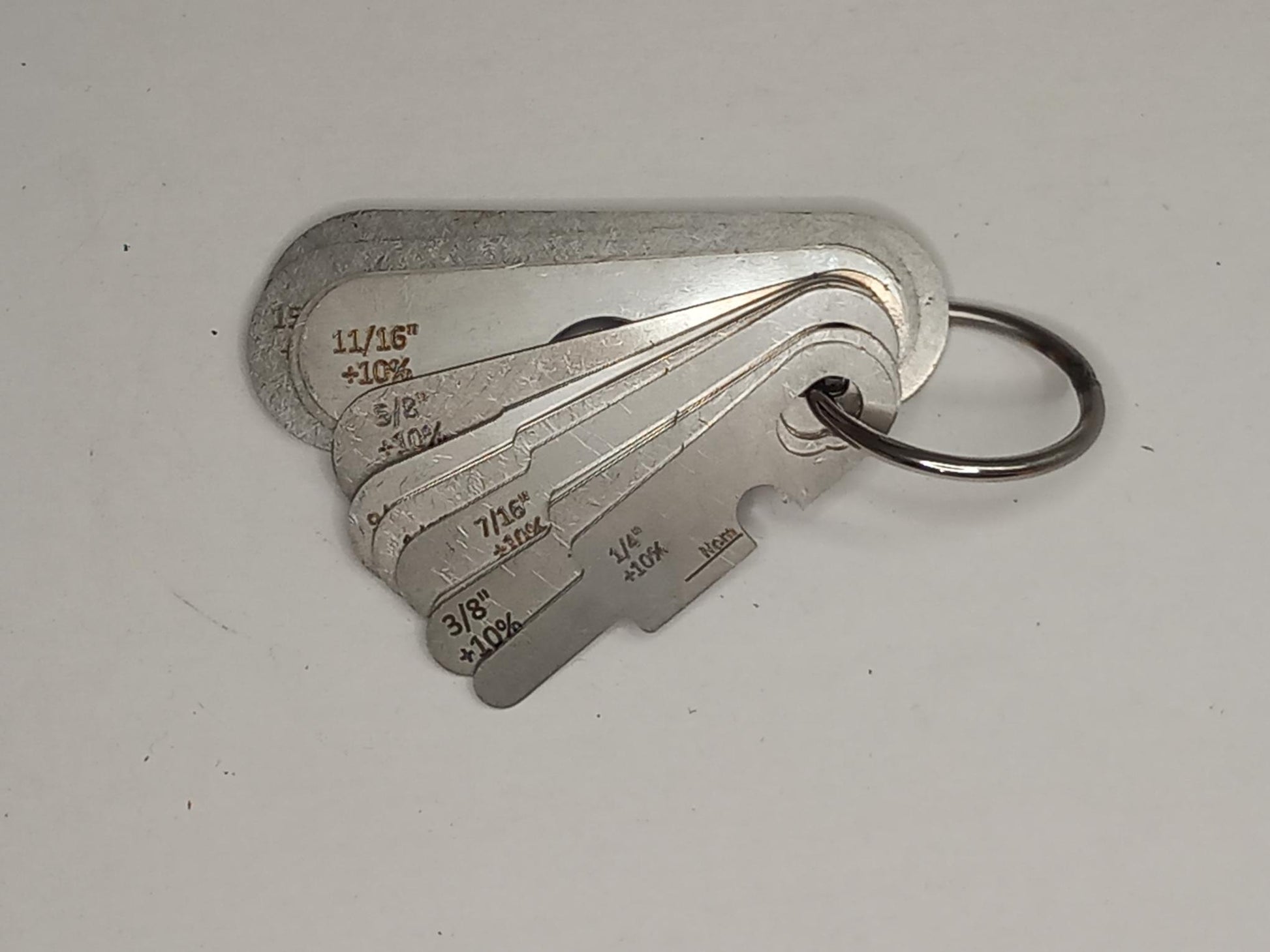 Metal measuring tool set with various scales on a grey background