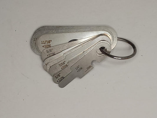 Metal measuring tool set with various scales on a grey background