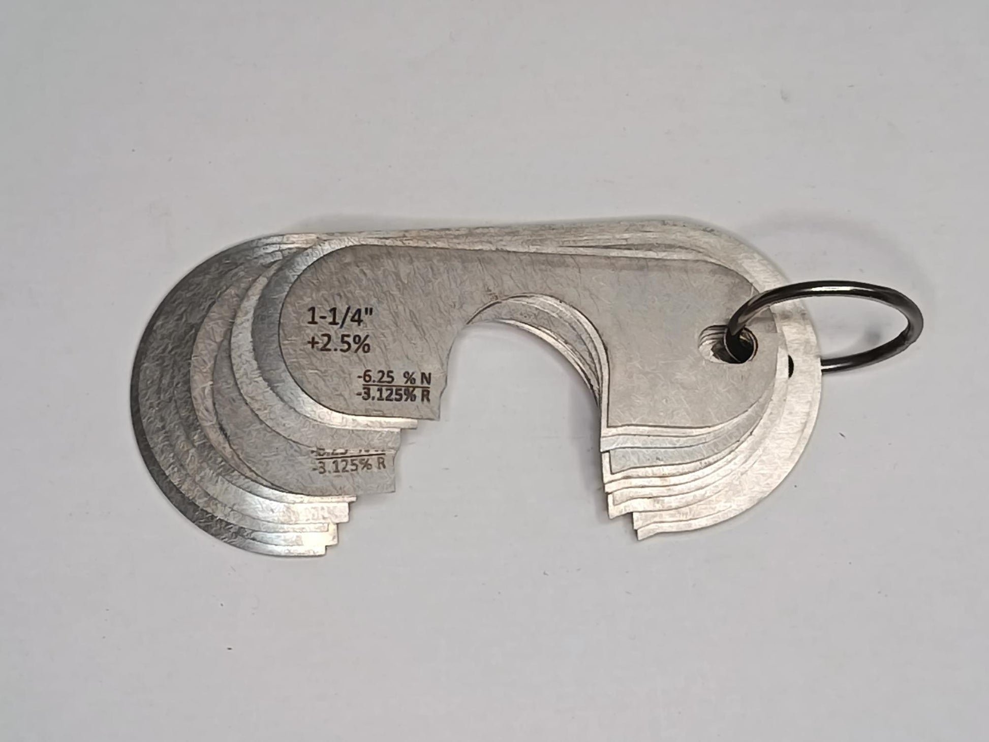 Metal measuring tool set with various scales on a grey background