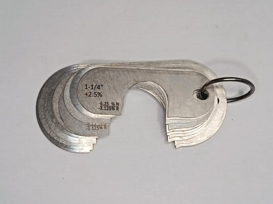 Metal measuring tool set with various scales on a grey background
