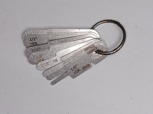 Metal measuring tool set with various scales on a grey background