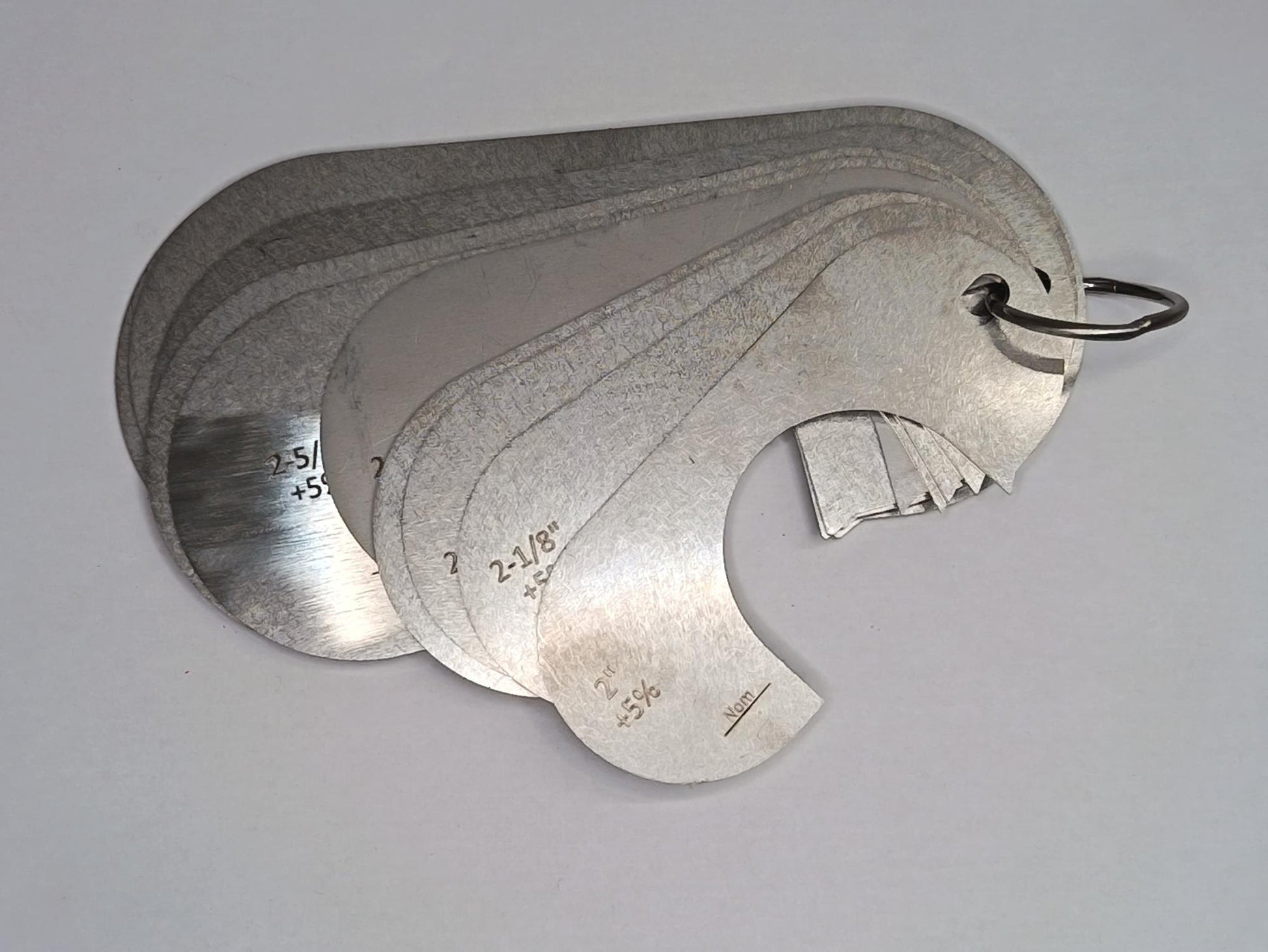 Metal measuring tool set with various scales on a grey background
