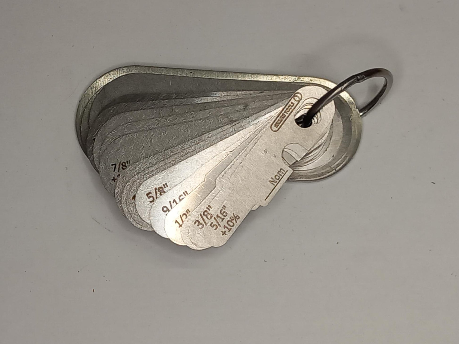 Metal measuring tool set with various scales on a grey background
