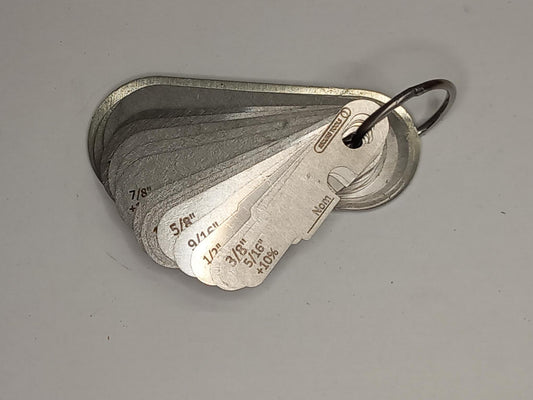 Metal measuring tool set with various scales on a grey background