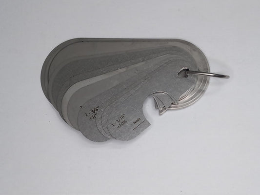 Metal measuring tool set with various scales on a grey background