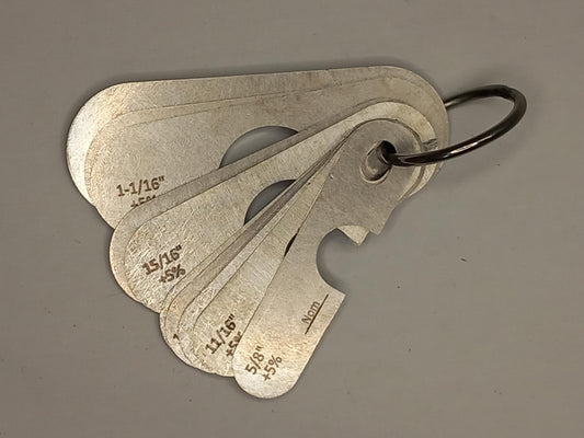 Metal measuring tool set with various scales on a grey background