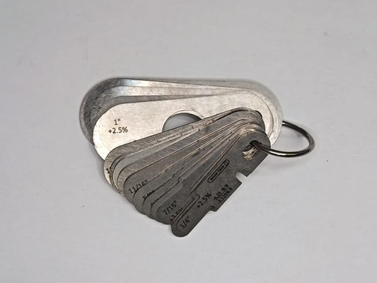 Metal measuring tool set with various scales on a grey background