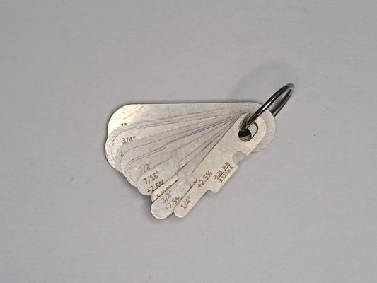 Metal measuring tool set with various scales on a grey background